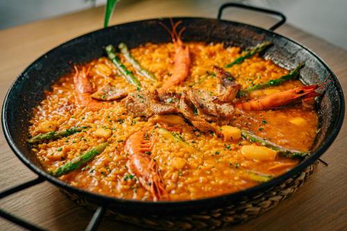 a bowl of food with shrimp and asparagus at Costa del Sol Glamping Village in Fuengirola