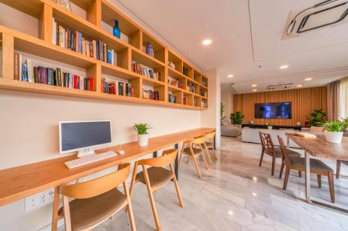 an office with a long table with a computer on it at Playa Esperanza Resort Affiliated by Meliá in Playa de Muro