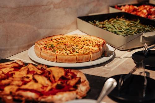 a pizza sitting on top of a table next to a pizza at voco Paris - Porte de Clichy by IHG in Clichy