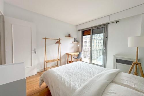 une chambre blanche avec un lit et une fenêtre dans l'établissement Flexliving - room - Ternes, à Paris