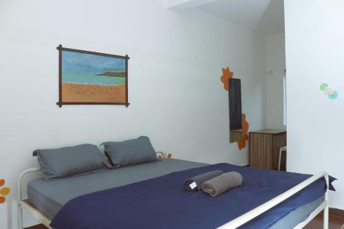 a bedroom with a bed and a picture of a beach at Summer Hostel in Palolem