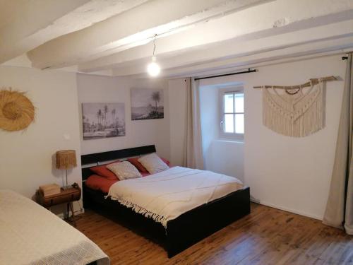 a bedroom with a bed and a window at La Casa del Rio in Durtal