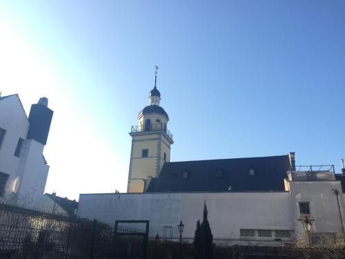 a building with a clock tower on top of it at Barcelona Bed & Breakfast in Düsseldorf