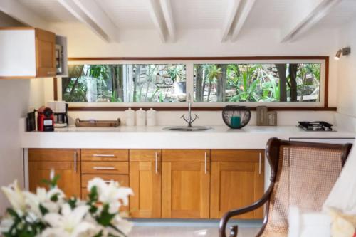a kitchen with a sink and a window at Romantic Bungalow near Beach with Shared Pool in Saint Barthelemy