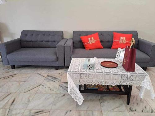 a living room with a couch and a table at HAPPY HOMESTAY Lukut NS in Port Dickson