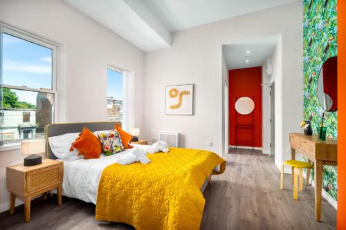 a bedroom with a yellow bed and a red door at Spacious Stylish Apartment - City Centre - Secure Parking - 1SH in Birmingham