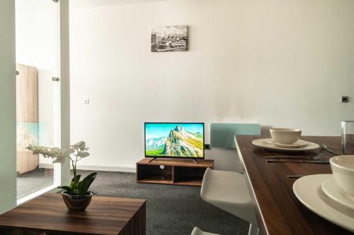 a living room with a television on a table at Fabulous 1 Bed Apartment in Central Blackburn in Blackburn