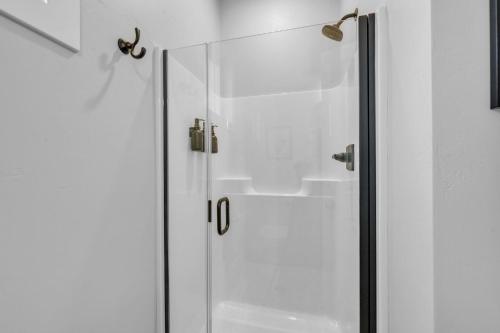 a shower with a glass door in a bathroom at Sunset Cove home in Oshkosh