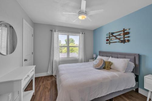 a bedroom with a bed and a desk and a window at Sunset Cove home in Oshkosh
