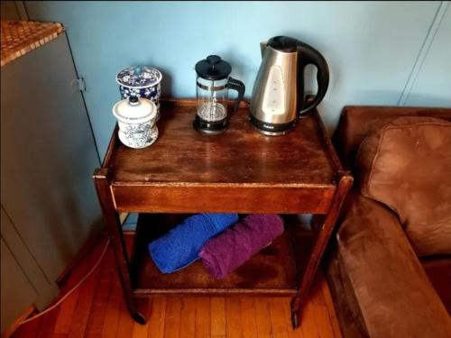 a table with a coffee maker on top of it at Backpacker's Dream with detached bathroom, private trails and creek! in Topanga Park