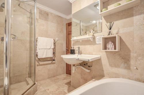 a bathroom with a sink and a shower and a toilet at Wave song in Yzerfontein