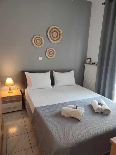 a bedroom with a bed with towels on it at One Bedroom Flat 300m from Sea in Alexandroupoli