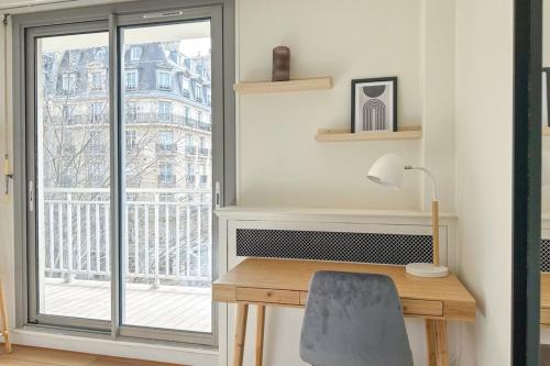 Cette chambre dispose d'un bureau et d'une grande fenêtre. dans l'établissement Flexliving - room - Ternes, à Paris