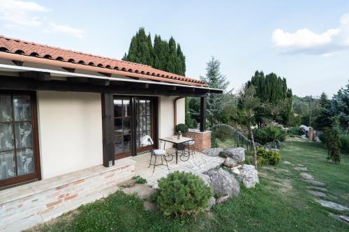 a patio of a house with a table and chairs at Villa Garden in Zalaegerszeg