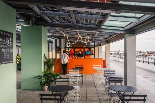 a restaurant with tables and chairs on a pier at The Circus Living in Berlin
