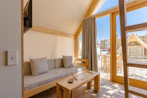a living room with a couch and a table at Costa del Sol Glamping Village in Fuengirola