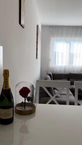 a bottle of wine sitting on a table next to a bottle of wine at Apartment Shine in Konik