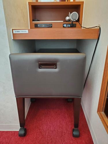 a desk with a drawer with a lamp on top at Benikea Calton Hotel Osaka Doutonbori in Osaka