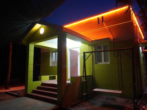 a small green house with a staircase in front at Ess Emm Farms in Vasavasamudram