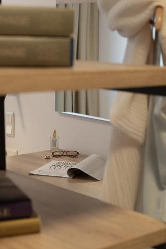 a book and glasses sitting on a shelf at Piraeus City Hotel in Piraeus