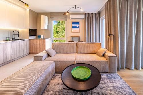 a living room with a couch and a table at Nautica Resort in Giżycko