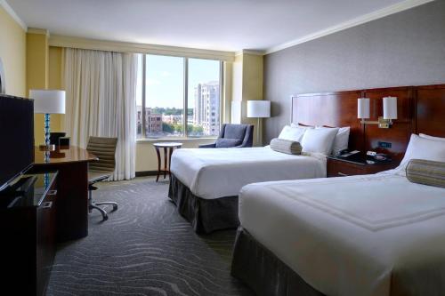 a hotel room with two beds and a large window at Newport News Marriott at City Center in Newport News