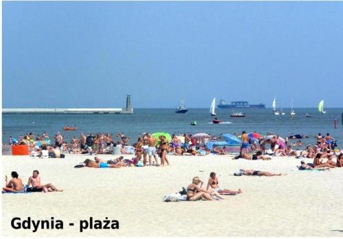 a large group of people on a beach at Apartament Faltom 6 Yacht Park Premium in Gdynia