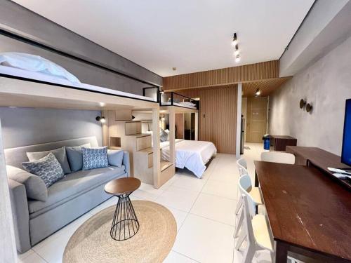 a room with a couch and a bed and a table at Miranda B 319 at Pico de Loro by Raquels Place in Nasugbu