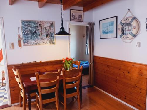 a dining room with a table and chairs at De Stormmeeuw in Egmond aan Zee