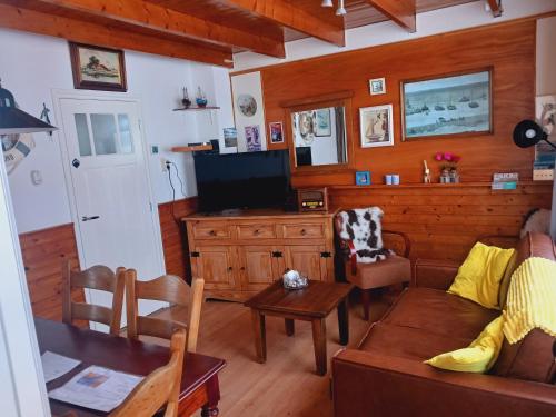 a living room with a couch and a table at De Stormmeeuw in Egmond aan Zee