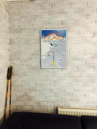 a picture hanging on a white brick wall at Perfect Located Apartment in the heart of Hotham in Mount Hotham