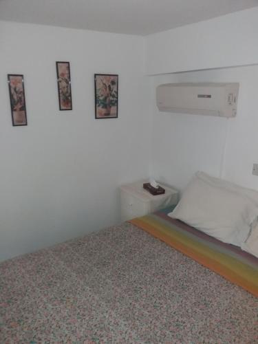 a white room with a bed with a rainbow at Greenfields Country Club in Limassol