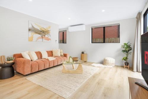 a living room with a couch and a table at Spacious Stunner! Central, King Bed -By KOSH BNB in Hamilton
