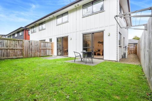 a white house with a green lawn in front of it at Spacious Stunner! Central, King Bed -By KOSH BNB in Hamilton