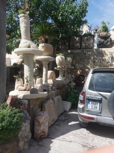 a fountain in a yard next to a car at Greenfields Country Club in Limassol