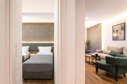 a living room with a bed and a couch at The five star apartment-Tsimiski street in Thessaloniki
