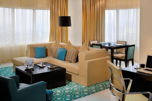 a living room with a couch and a table at Residence Inn by Marriott Manama Juffair in Manama