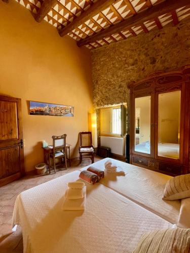 a bedroom with a large bed with two towels on it at Can Clarós in Capmany