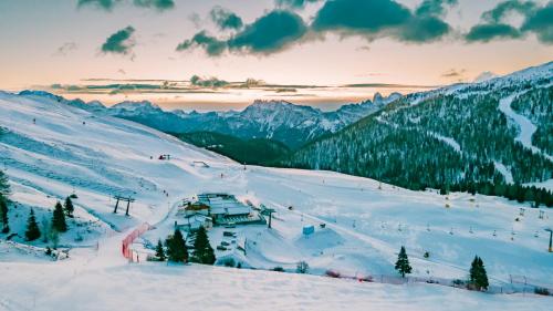 a ski lodge on a snow covered ski slope at Chalet Cima Uomo in Passo San Pellegrino