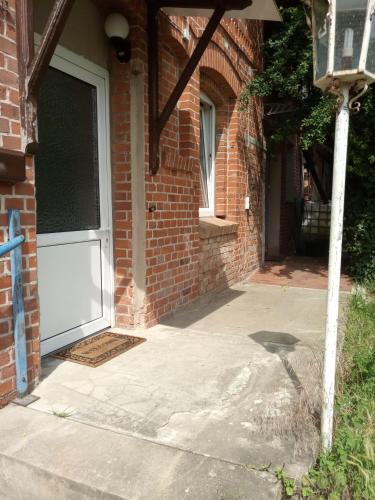 a door to a brick building with a driveway at gemütliche Unterkunft II in Bretsch