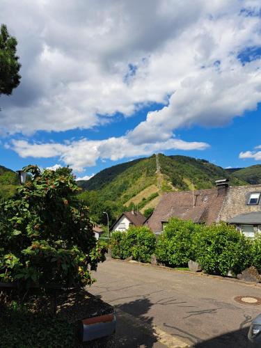 a view of a hill with houses and a mountain at Ferienwohnung Wandereck in Boppard