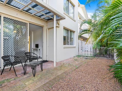 a patio with two chairs and a table at Miami Beachside Holiday Apartments in Gold Coast