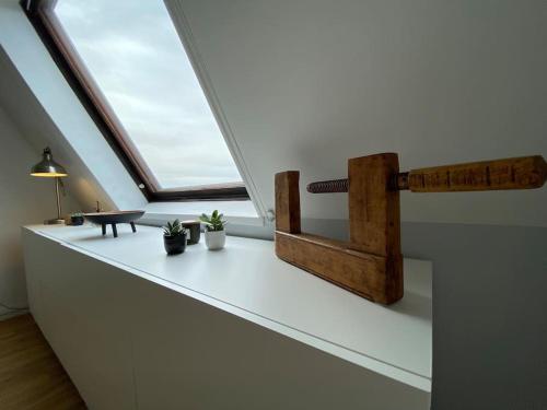 - une lucarne dans une chambre avec une table et une fenêtre dans l'établissement Bel Cabourg - Proche plage & Centre Cabourg, à Cabourg