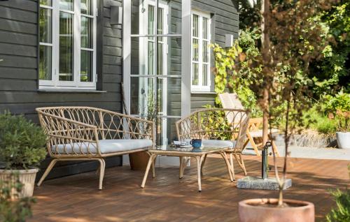 two chairs and a table on a patio at 3 Bedroom Lovely Home In Jægerspris in Jægerspris