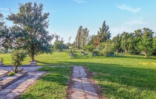 a stone path through a park with a tree at Lovely Home In Monclar-De-Quercy in Monclar-de-Quercy