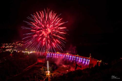 a firework display with a bridge in the background at night at Ferienwohnung Sporn in Hemfurth-Edersee