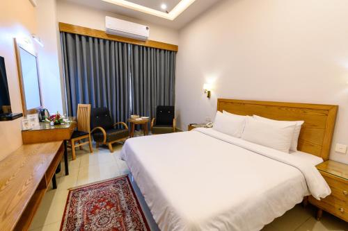 Postel nebo postele na pokoji v ubytování Hotel One Mansehra