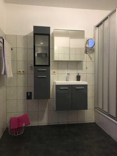 a bathroom with a sink and a mirror at Ferienwohnung Sporn in Hemfurth-Edersee