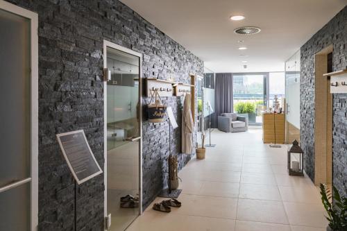 a hallway of a store with a brick wall at Heiner's Parkhotel in Gelsenkirchen