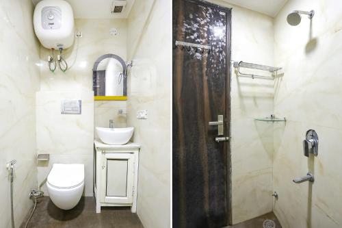 a bathroom with a toilet and a sink and a shower at Comfy Stay Hotels 2nd Floor in New Delhi